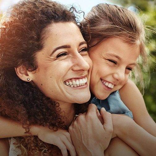 Mother and daughter smiling