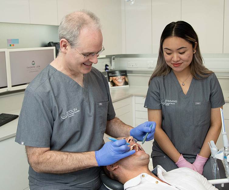 Dr Colin Houston treating a patient with a dental nurse
